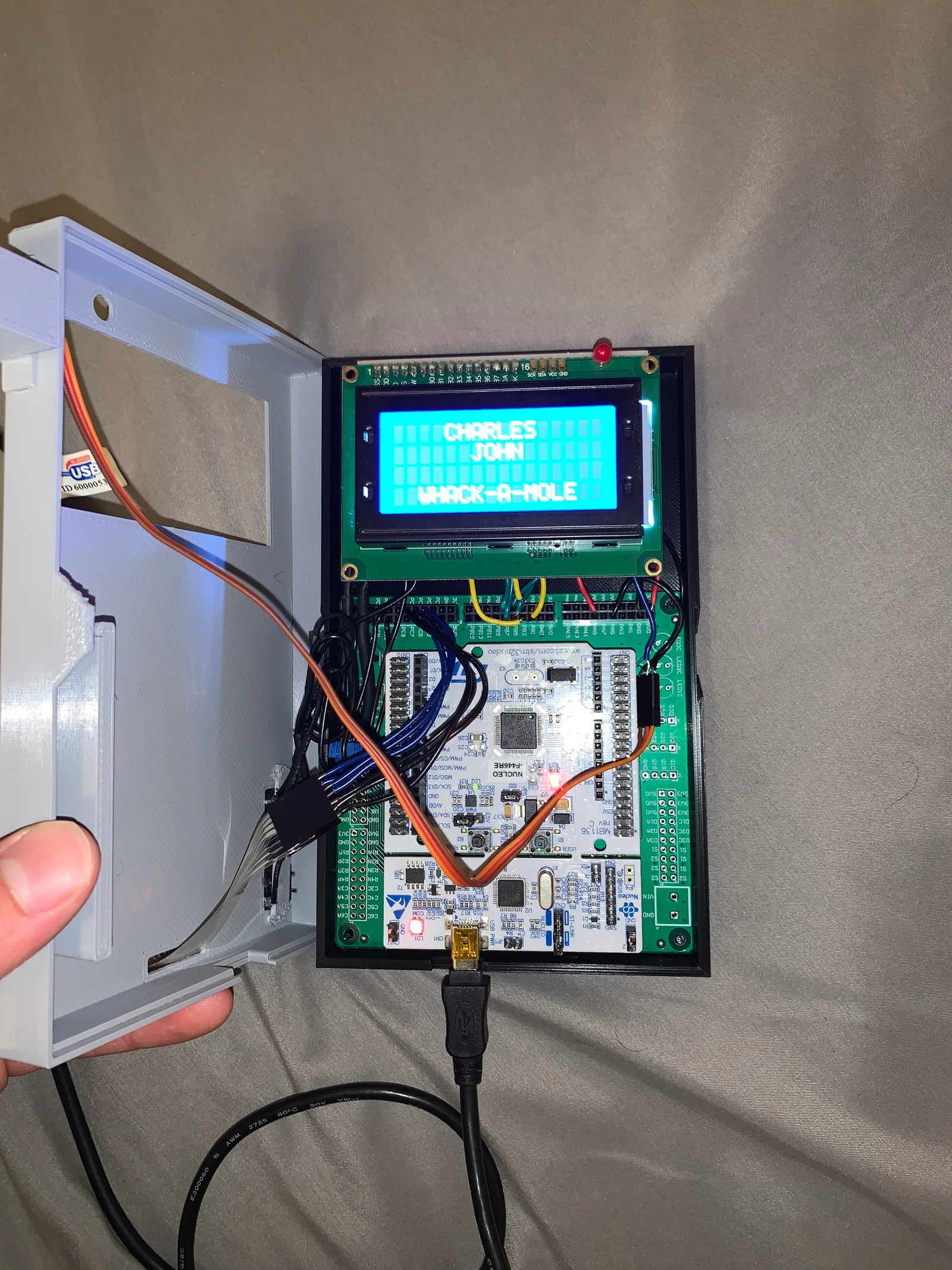 The enclosure opened to show the LCD, controller boards, and wiring